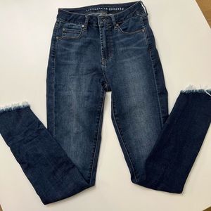 High rise stretch asymmetrical raw hem skinny jeans